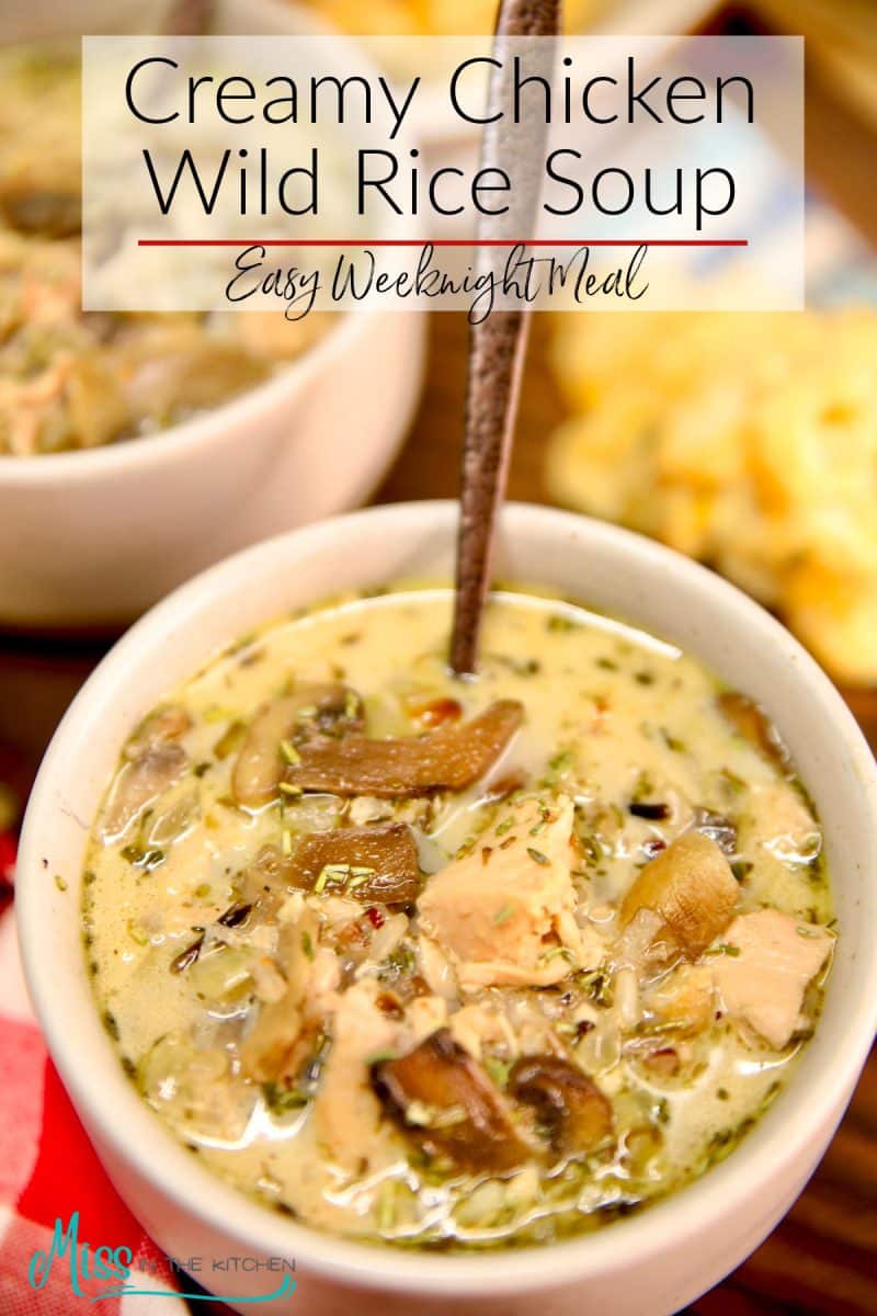Creamy chicken wild rice soup in a bowl with spoon. Text overlay.