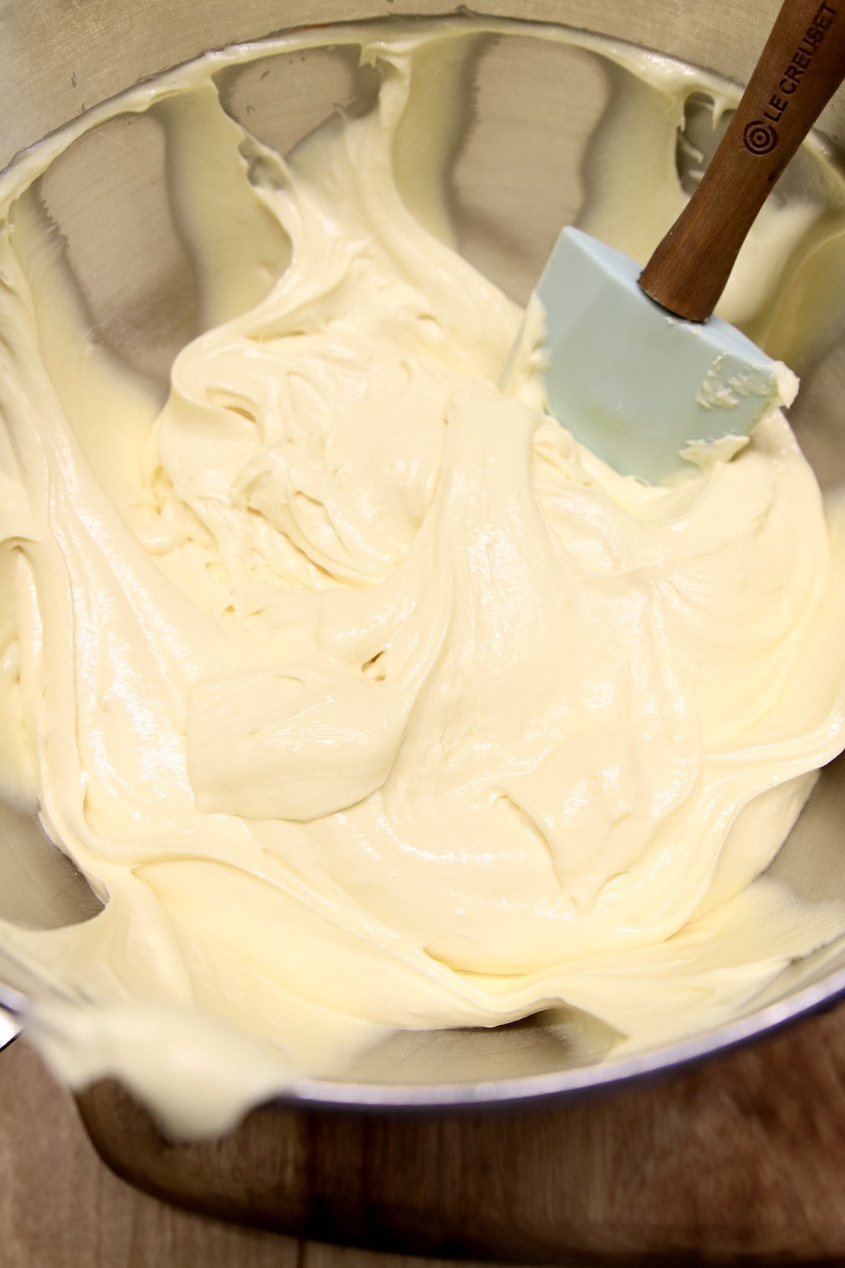 butter cake batter in a mixer bowl with rubber spatula