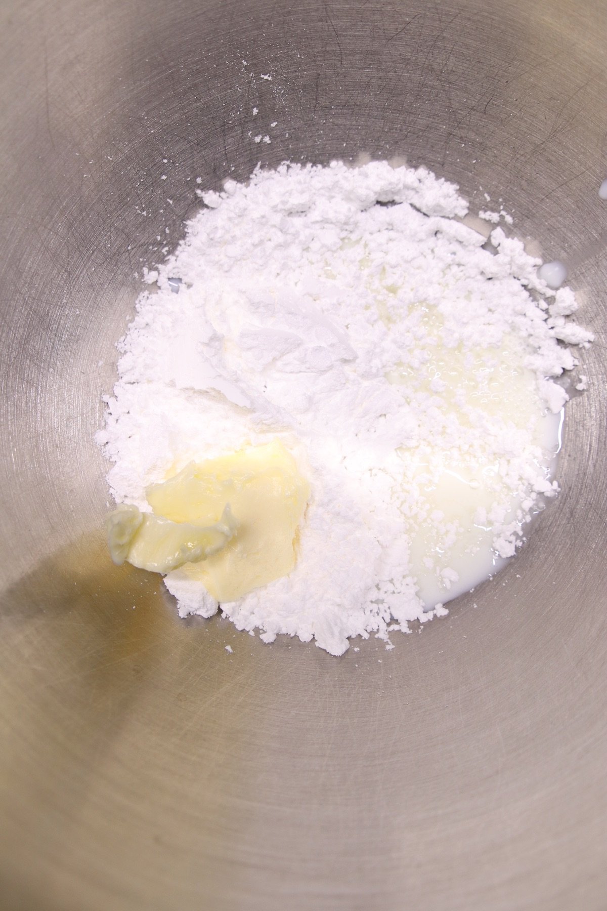 powdered sugar, butter and milk in a bowl
