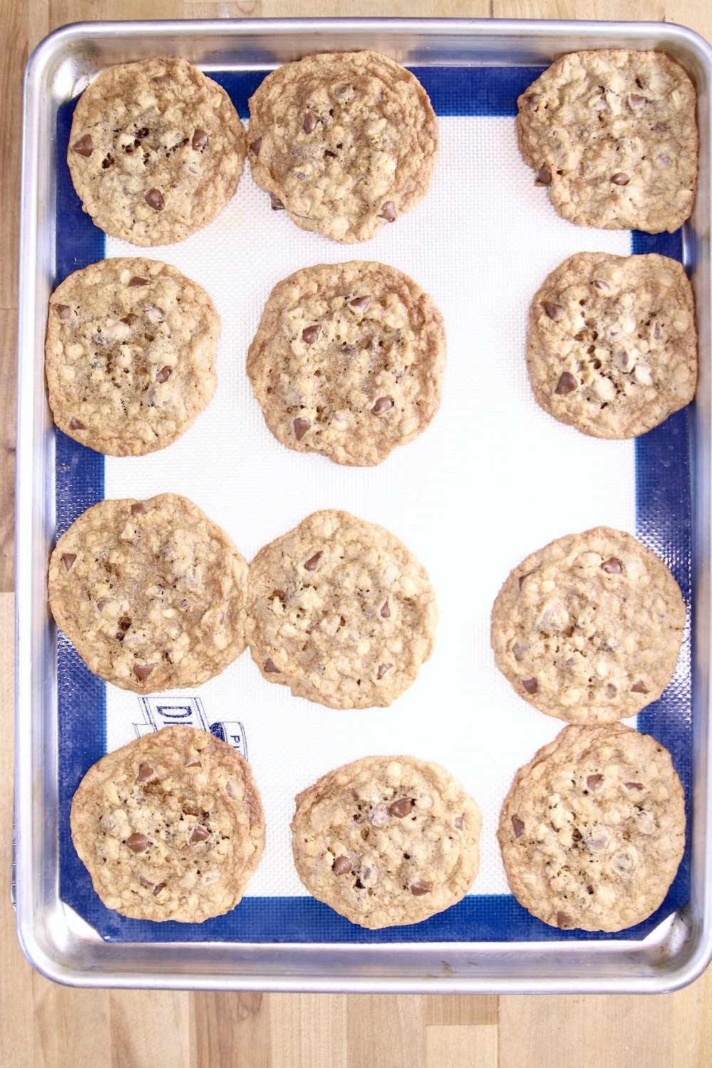 baked chocolate chip cookies on a silpat lined baking sheet