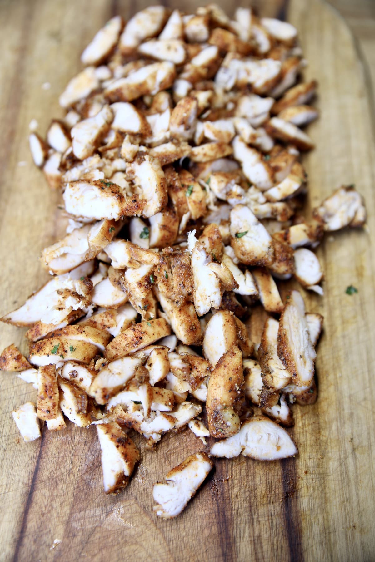 Diced grilled chicken on a cutting board.