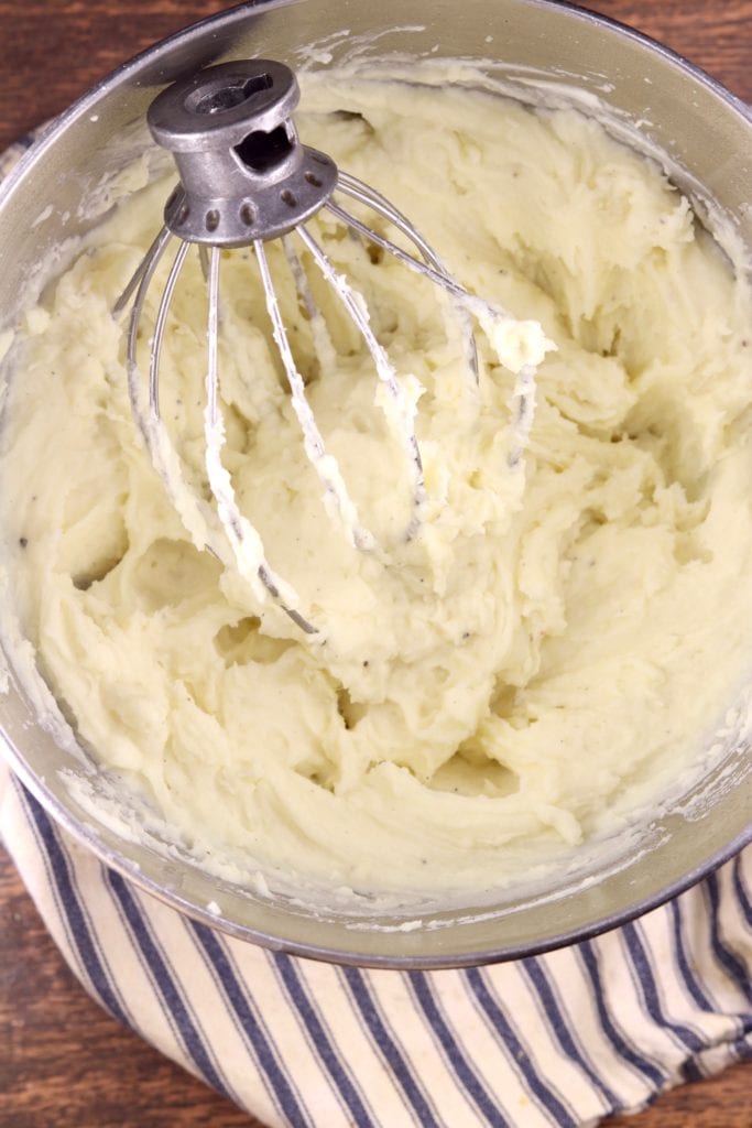 Bowl of whipped potatoes with whisk attachment