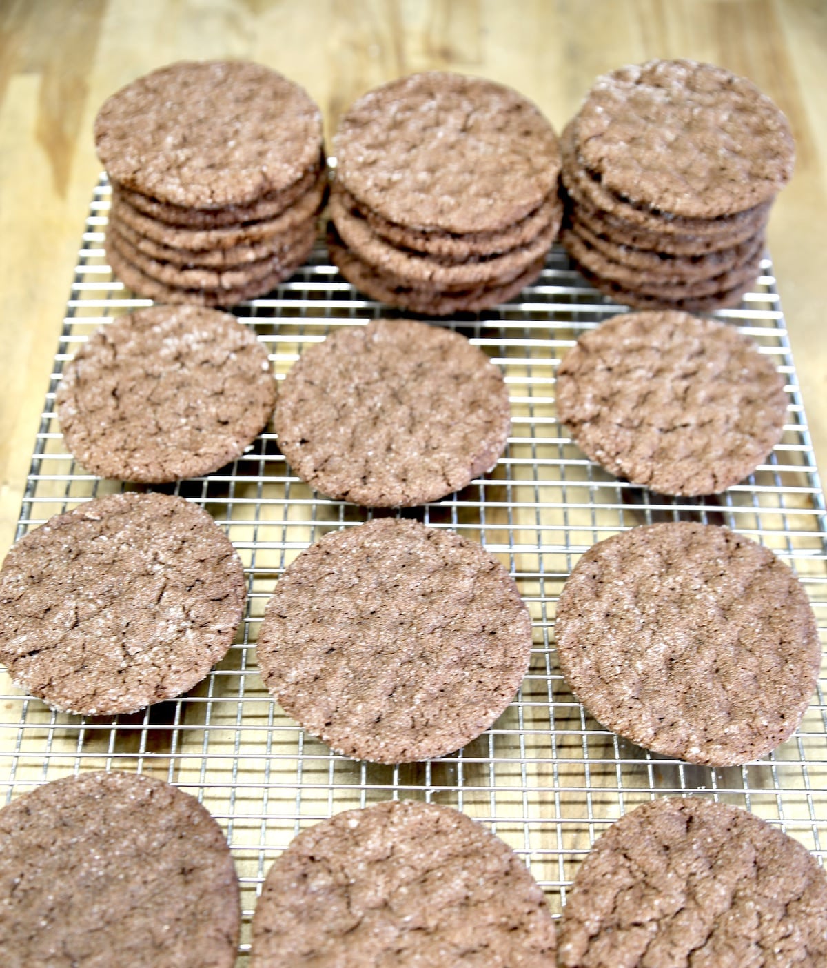 Baked chocolate cookies on a wire rack.