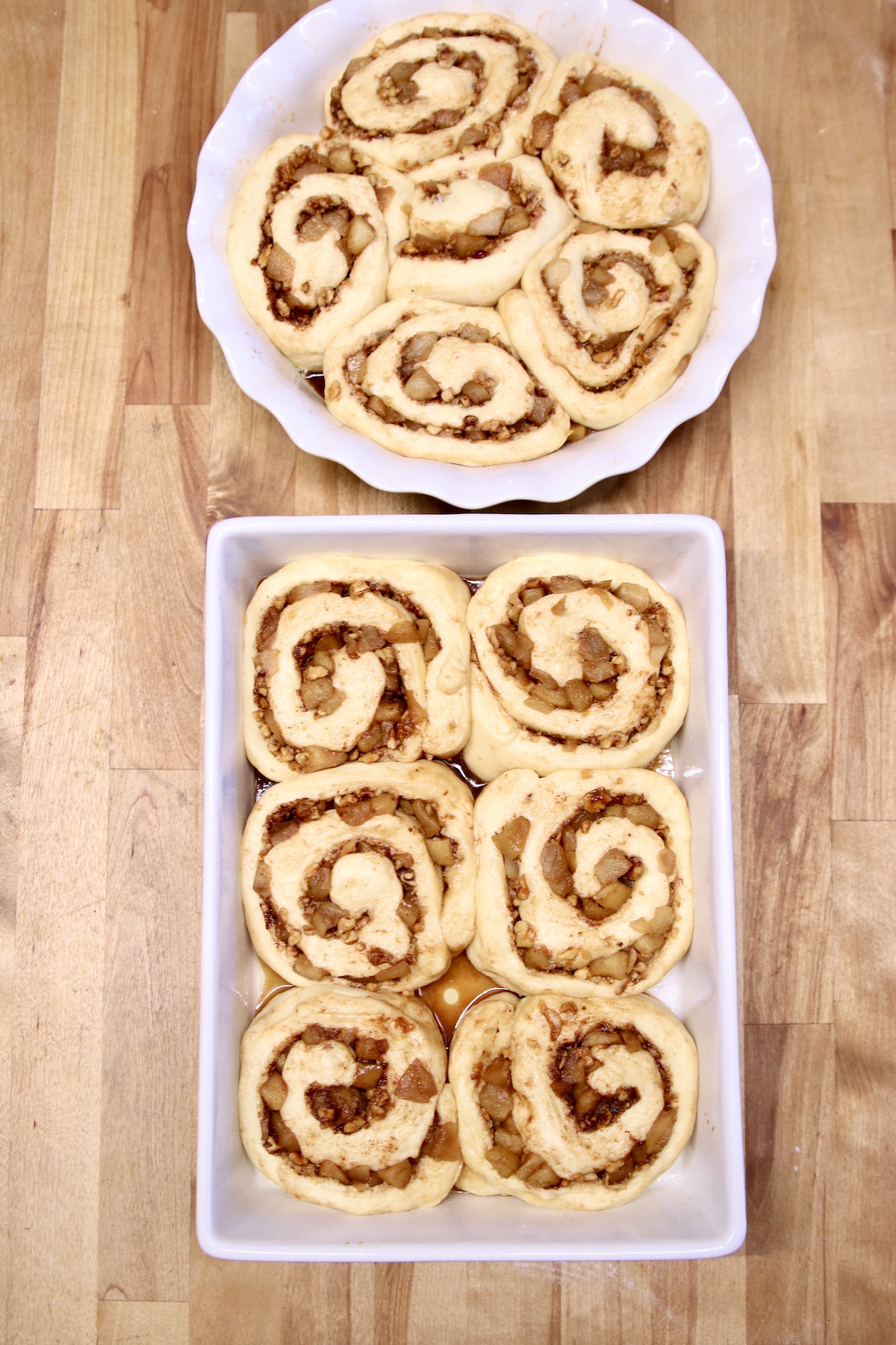 cinnamon rolls in a pie plate and baking dish - not baked
