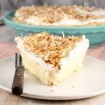 Coconut Cream Pie slice topped with whipped cream and toasted coconut