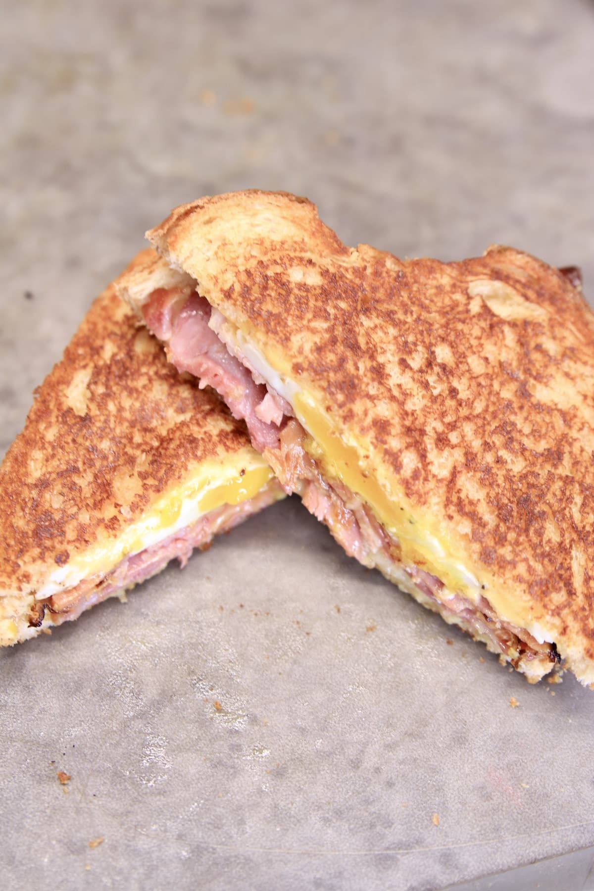 Ham and Egg Sandwich, toasted and cut in half.