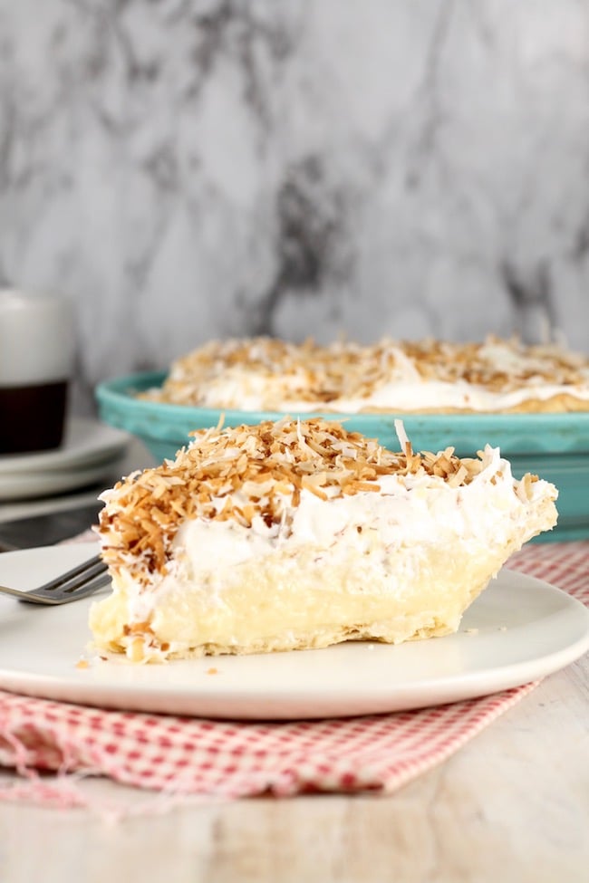 Coconut Cream Pie topped with whipped topping and toasted coconut