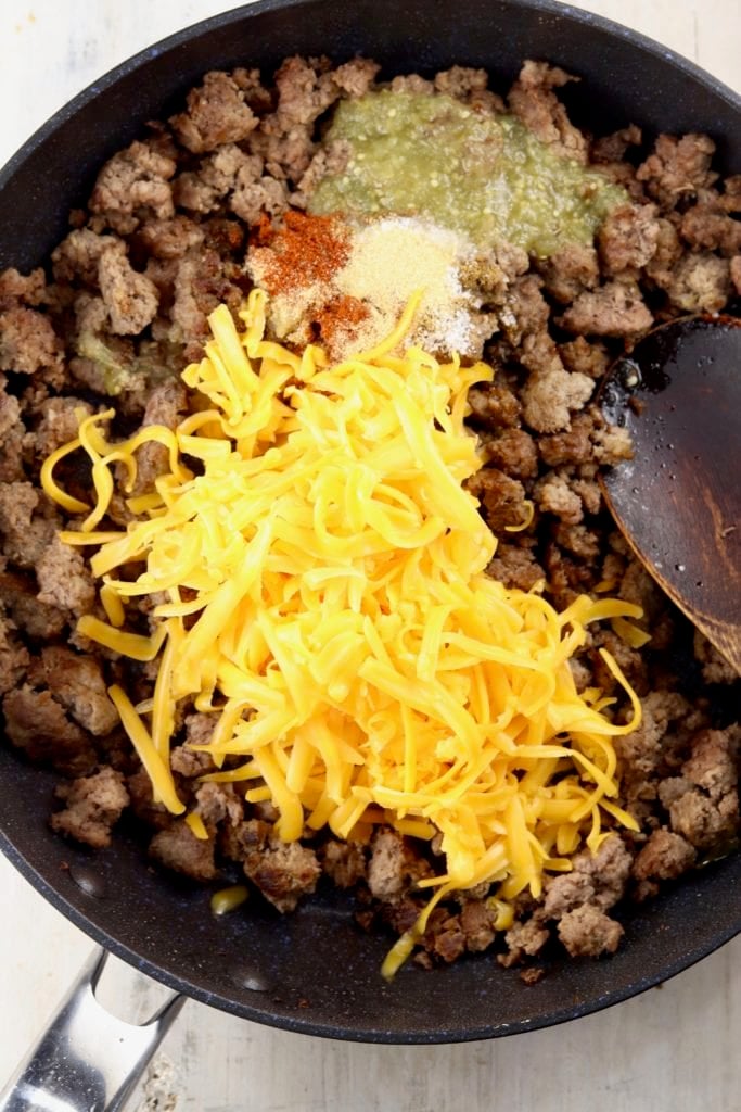 Skillet with ground beef, cheese, salsa and spices