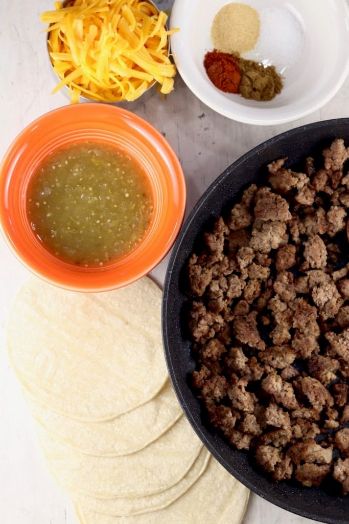 Ingredients for taquitos - ground beef, cheese, salsa, seasonings, tortillas
