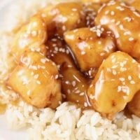 Sesame Chicken and rice in a white bowl