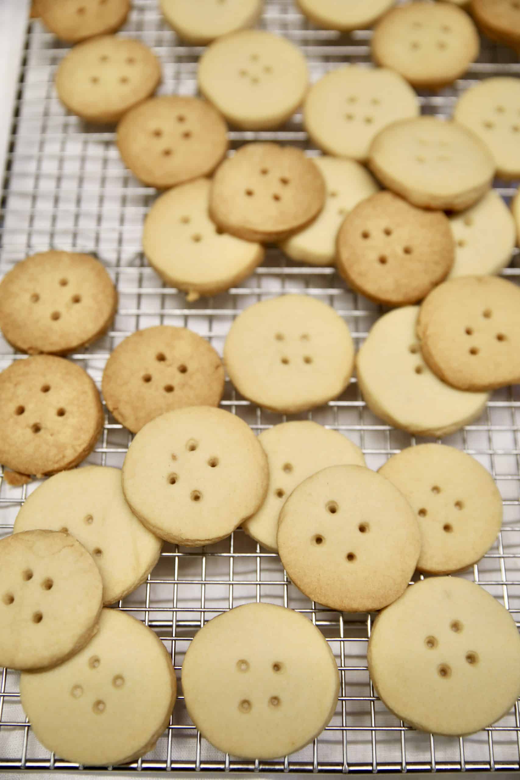 Shortbread buttons on a wire rack.