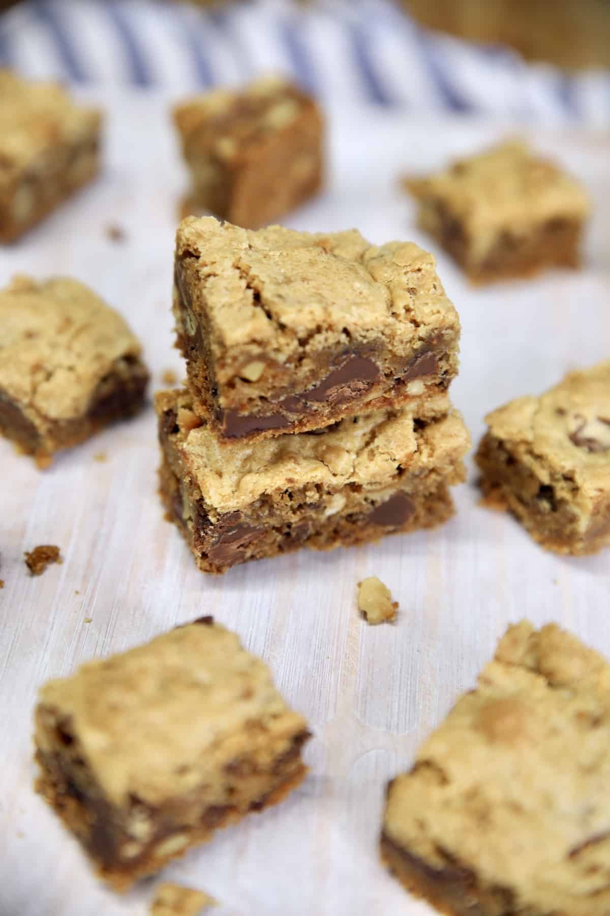 Cookie bars cut into small squares, some stacked.