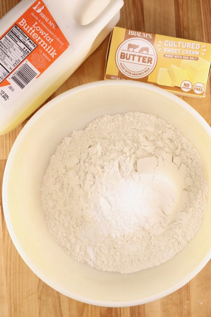Bowl of flour with butter and buttermilk for biscuits