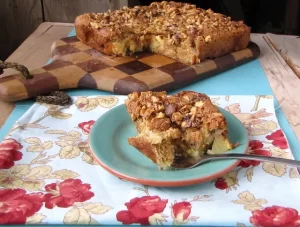 Maple-Walnut Apple Cake on blue plate with spoon.