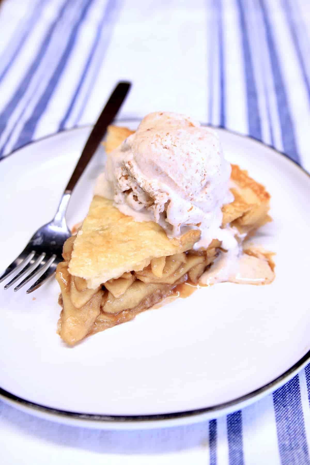 Slice of apple pie with ice cream. 