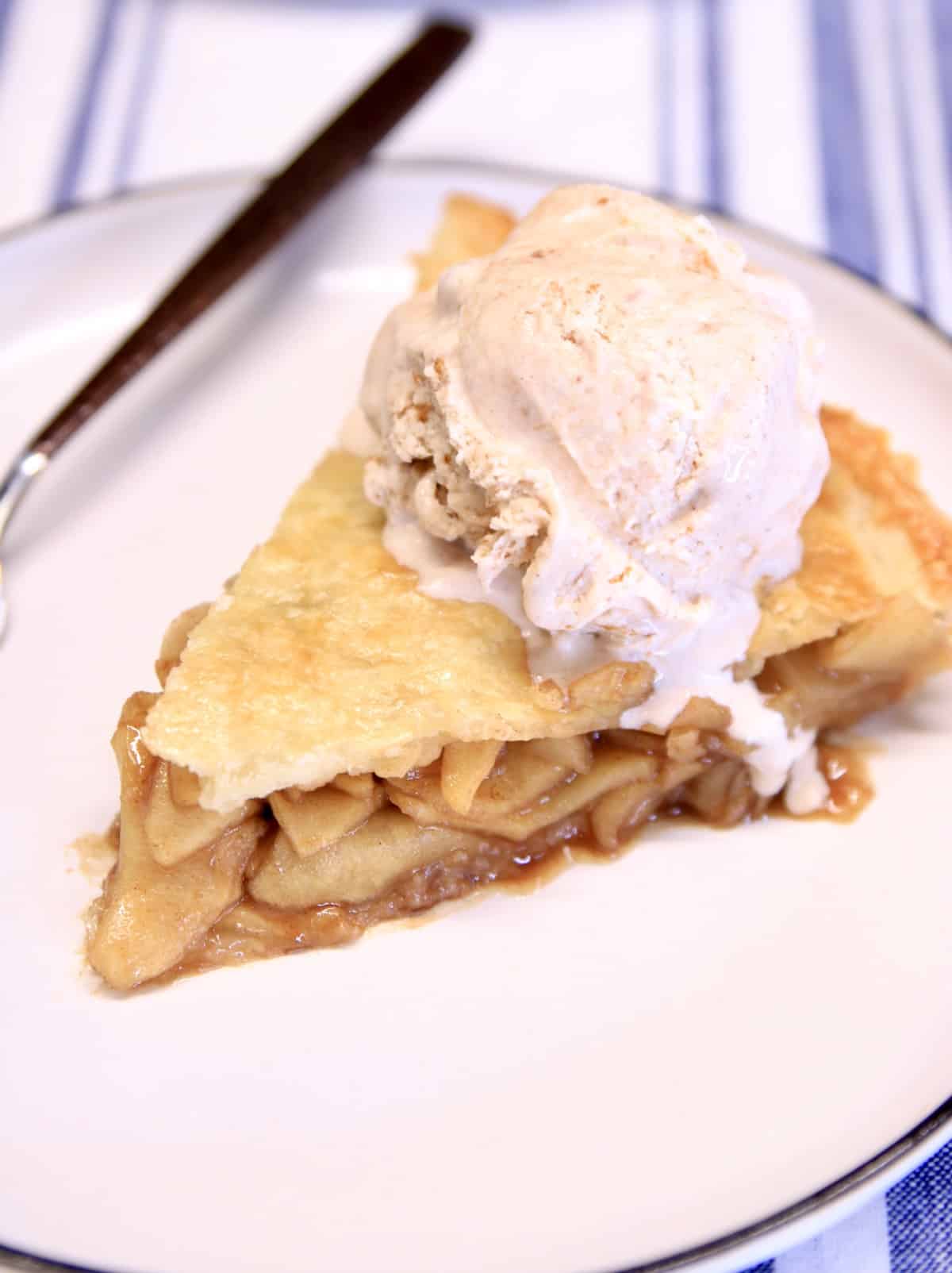 Slice of apple pie with cinnamon ice cream.