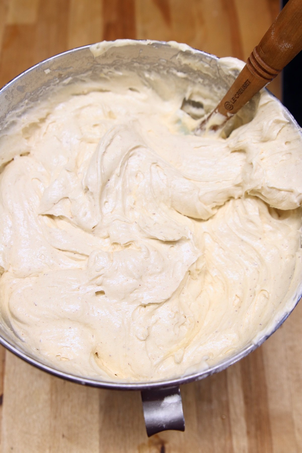 fluffy cake batter in a mixer bowl with spatula