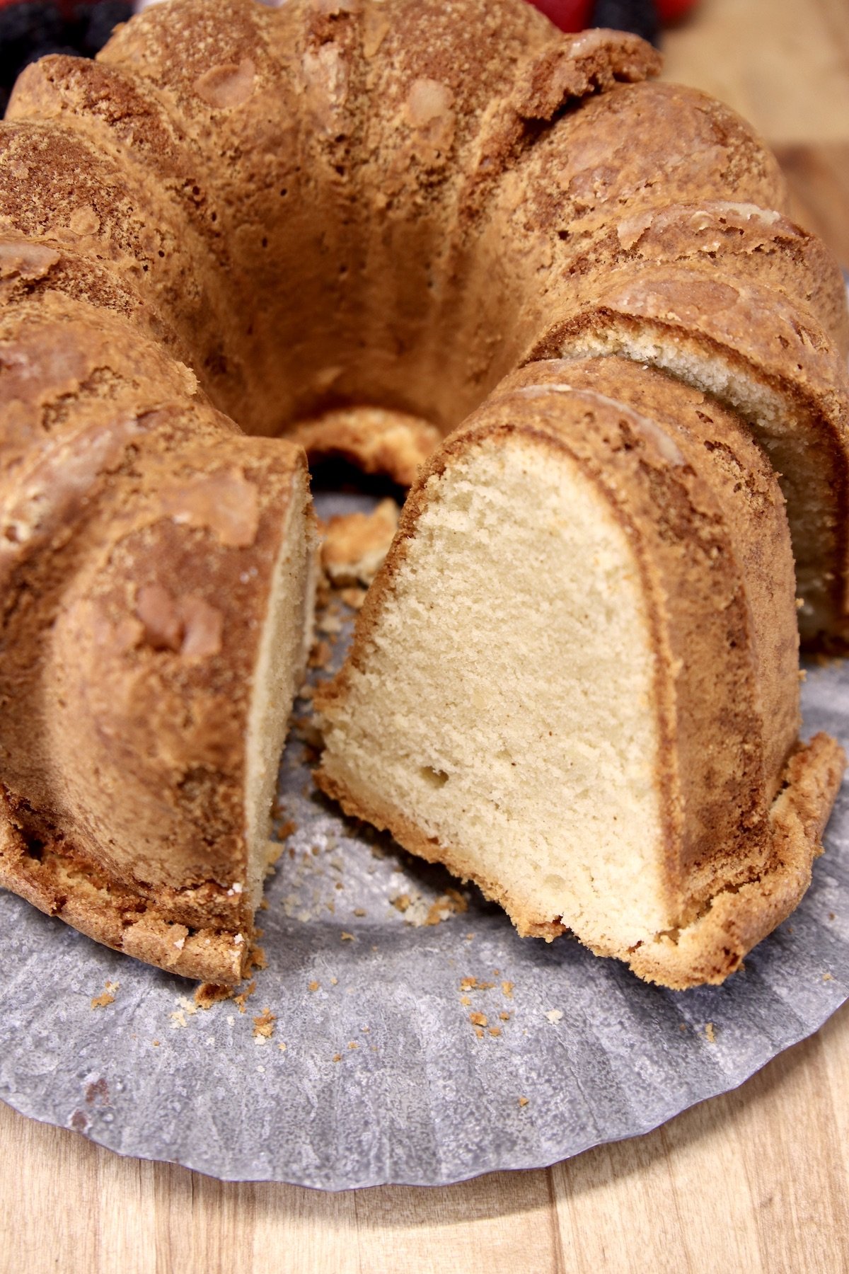 closeup of bundt cake, with one slice sitting on the edge