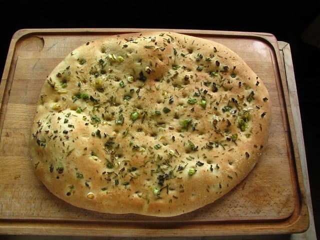 Focaccia bread on wooden platter