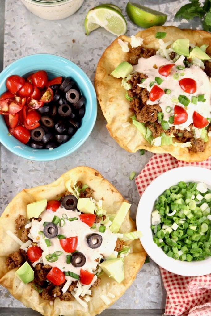Taco salads with tomatoes, olives and onions