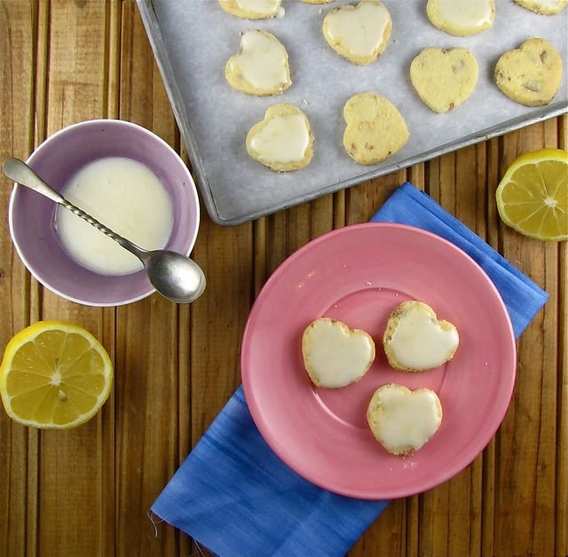 Shortbread hearts on plate by half lemon and icing 