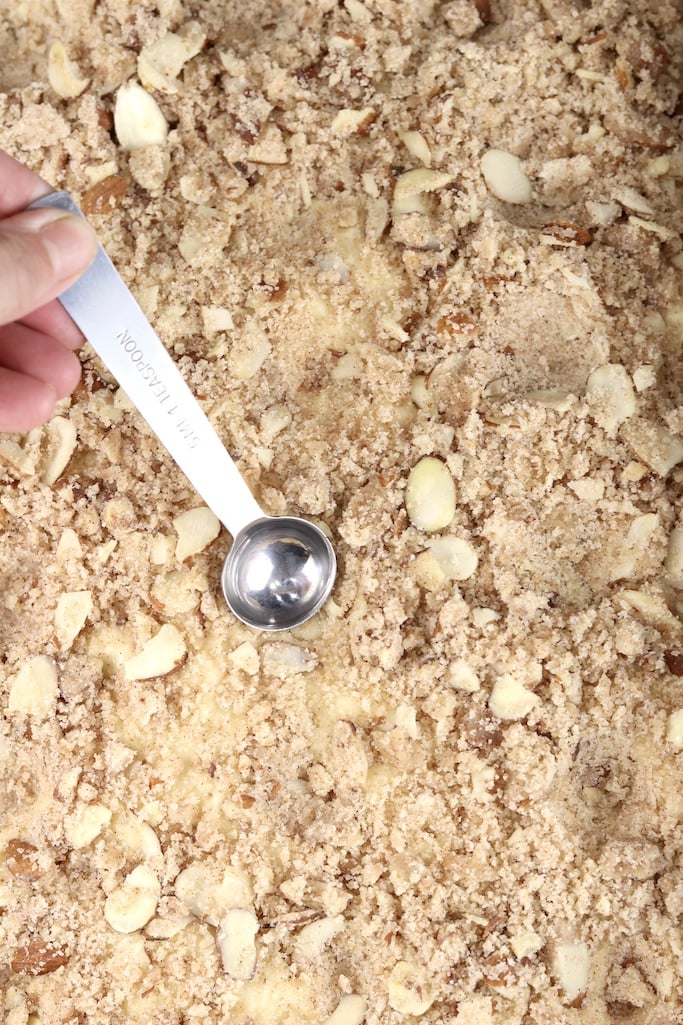 Indenting coffee cake dough with a spoon before rising