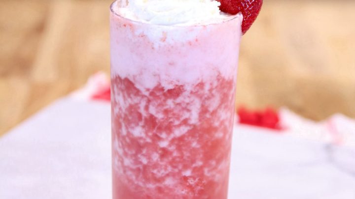 Strawberry Vodka Cocktail in a glass with whipped cream and strawberry