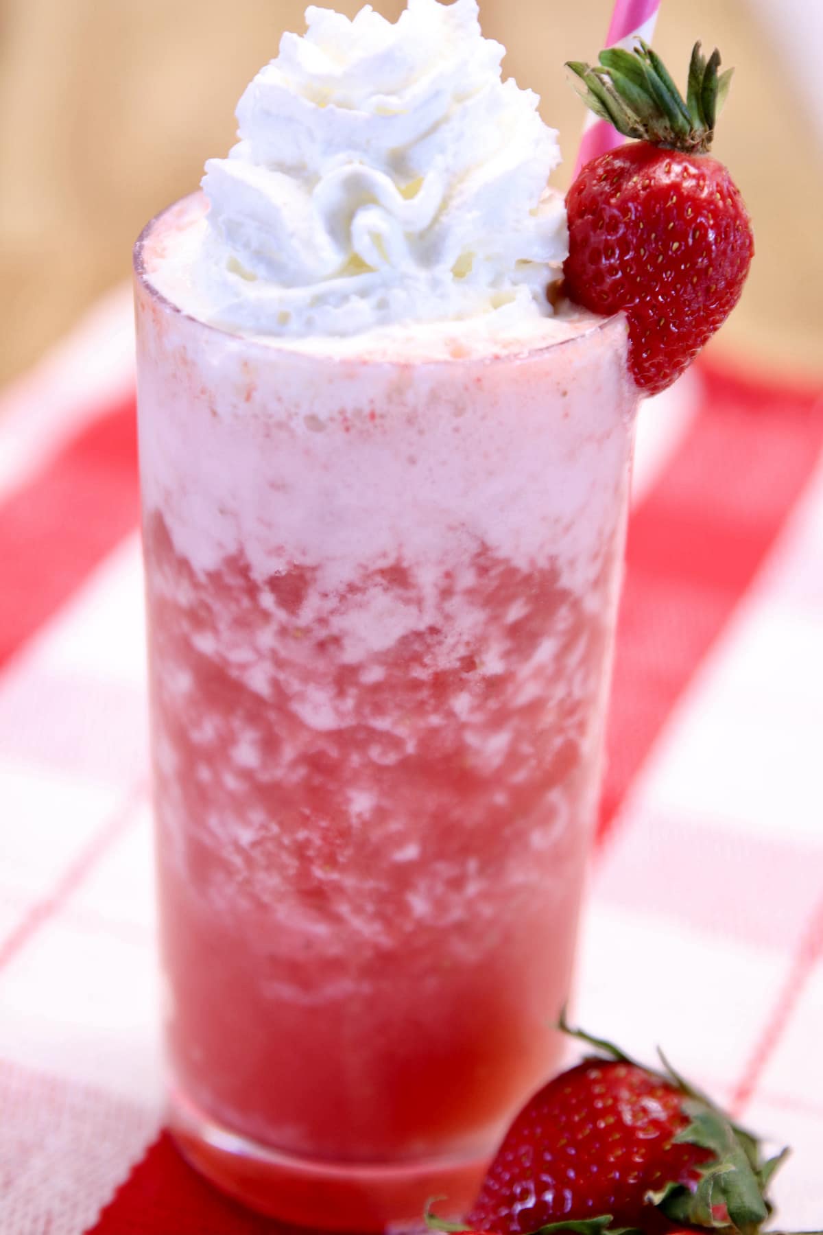 Strawberry Vodka Cocktail with whipped cream and strawberry garnish