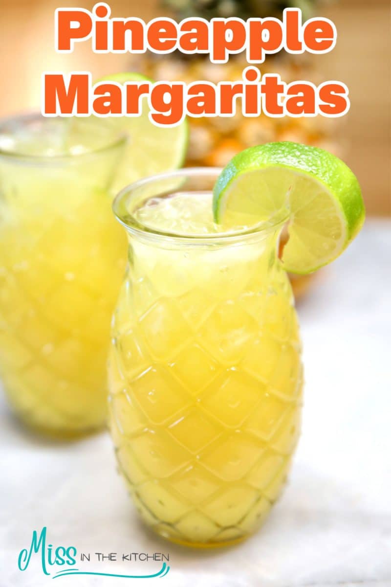 Pineapple Margaritas in tiki glasses- text overlay.