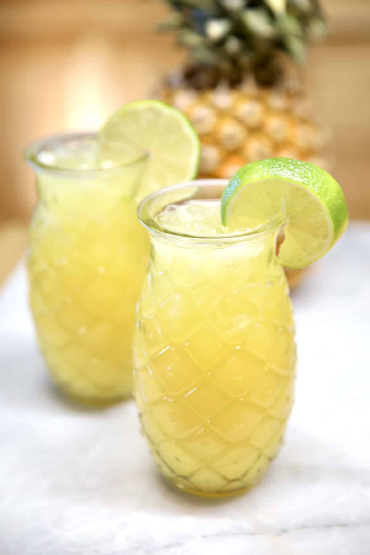 Pineapple Margaritas in tiki glasses.