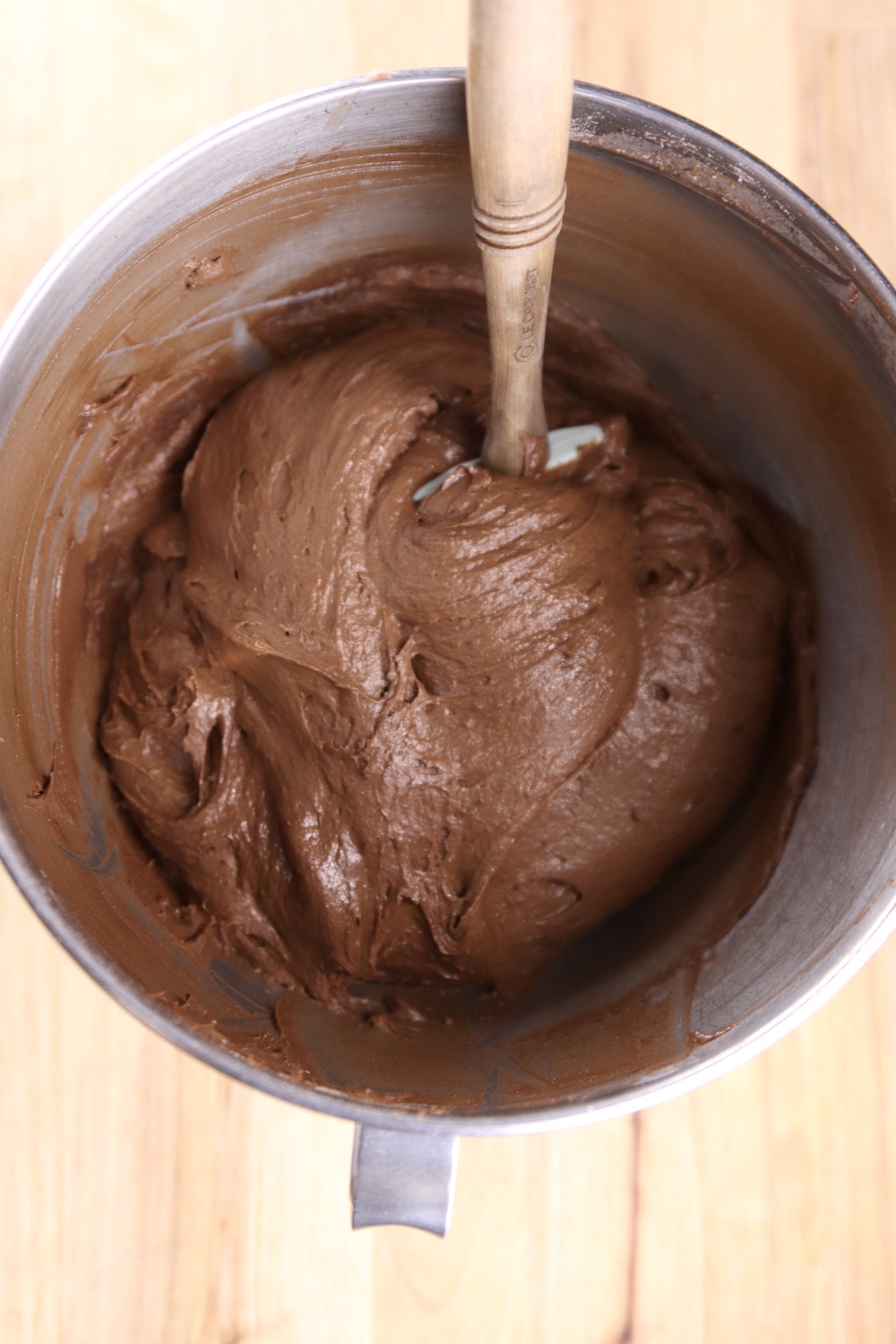 chocolate cake batter in a mixer bowl with spatula