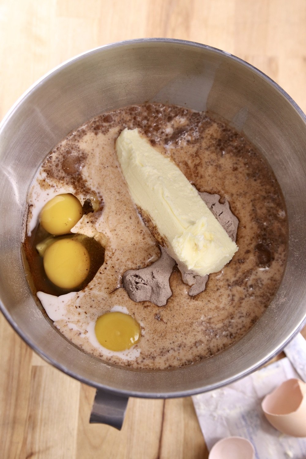 metal mixer bowl with cake mix, eggs, milk, butter and instant pudding mix
