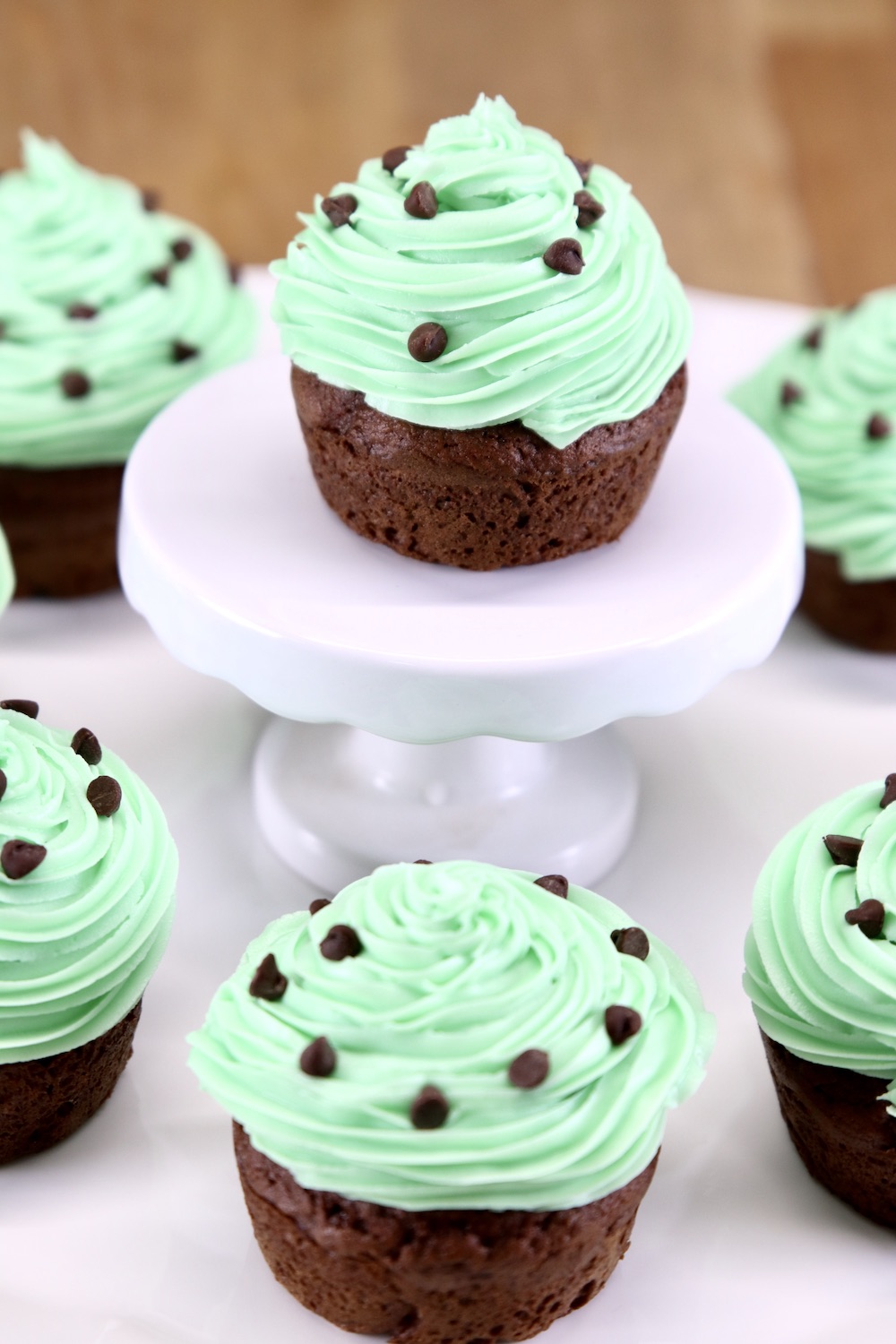 Chocolate mint cupcakes on a platter with one on a center pedestal