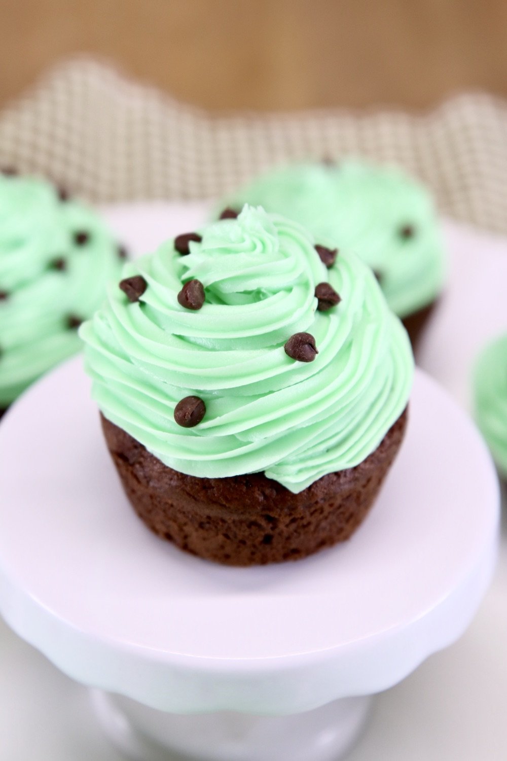 Mint Chocolate Cupcake with mini chocolate chips on a cupcake pedestal