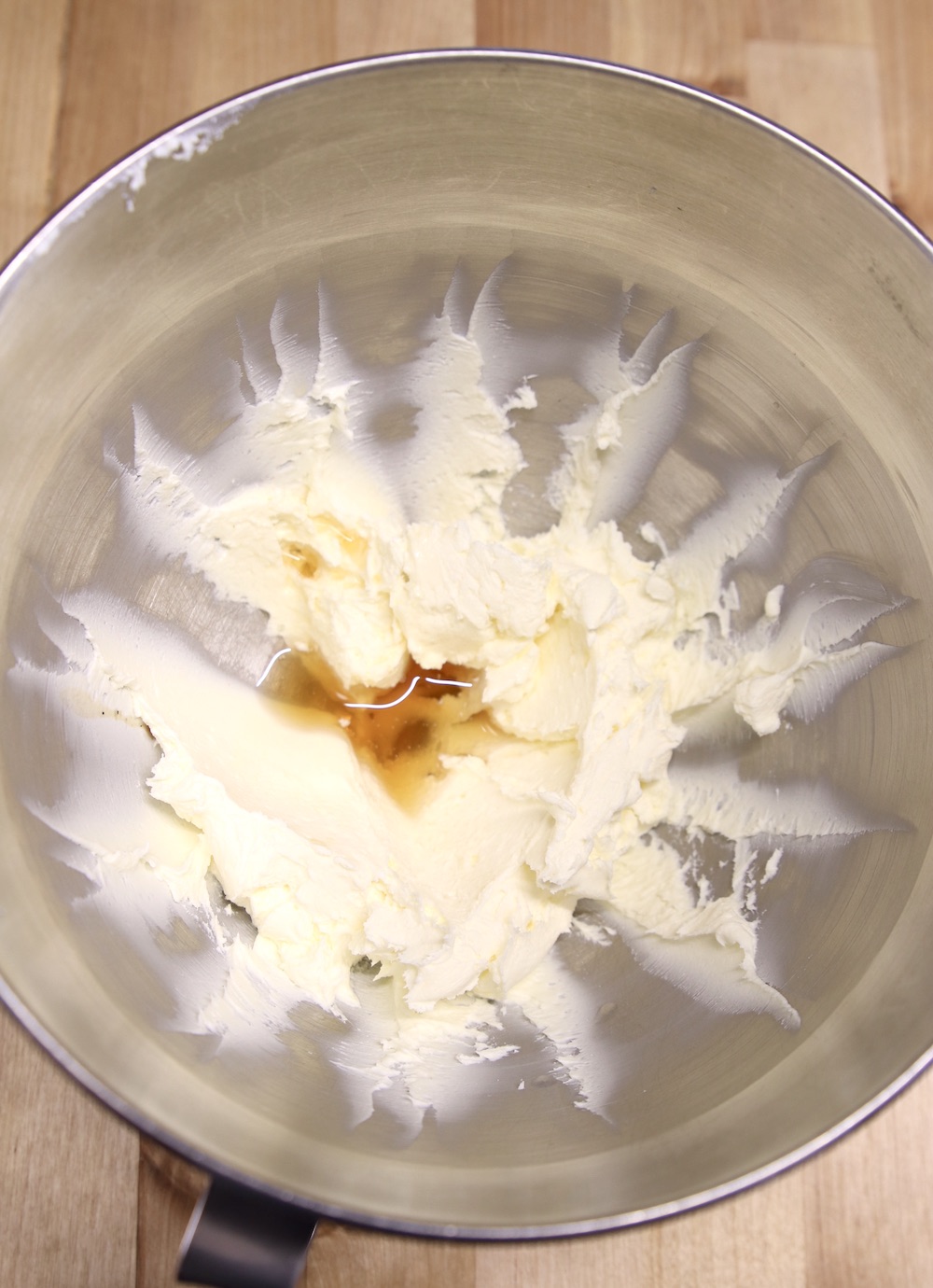 cream cheese mixture with vanilla and peppermint extract in mixer bowl