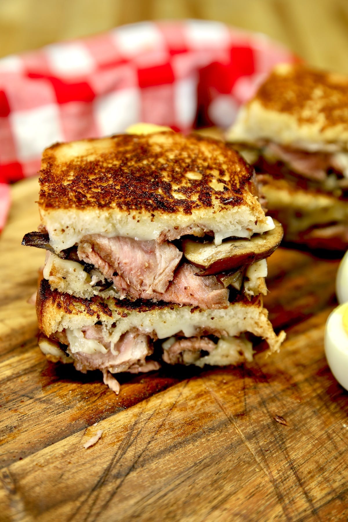 Steak Mushroom Swiss Grilled Cheese cut in half and stacked.