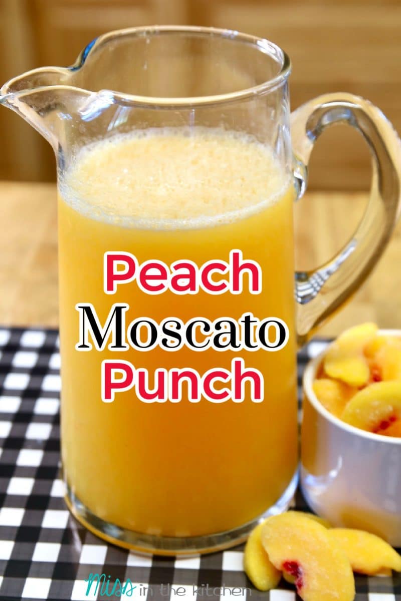 Pitcher of peach moscato punch with text overlay.