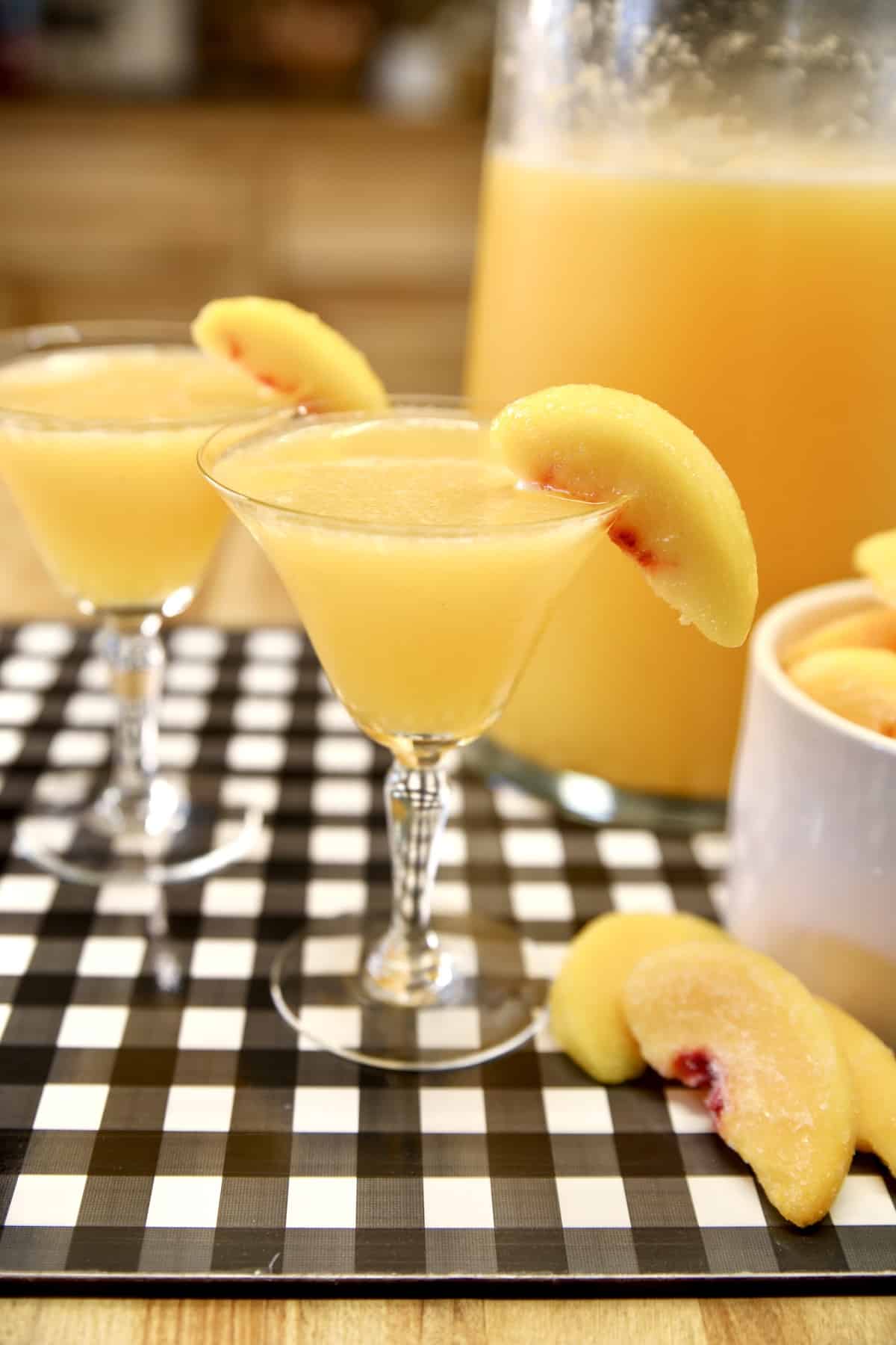 Peach wine punch in glasses, pitcher.