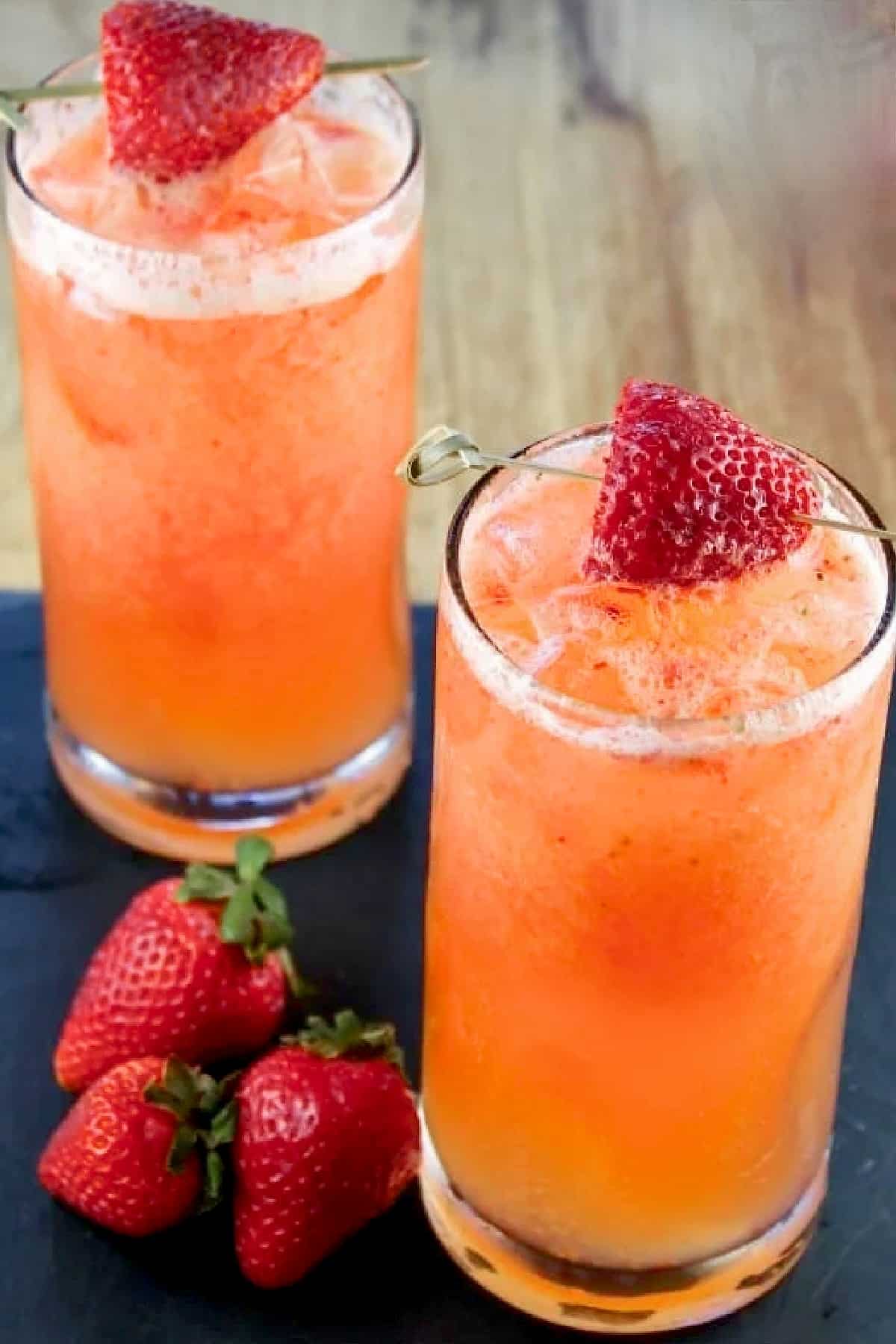 2 glasses of strawberry mango coolers with garnish.