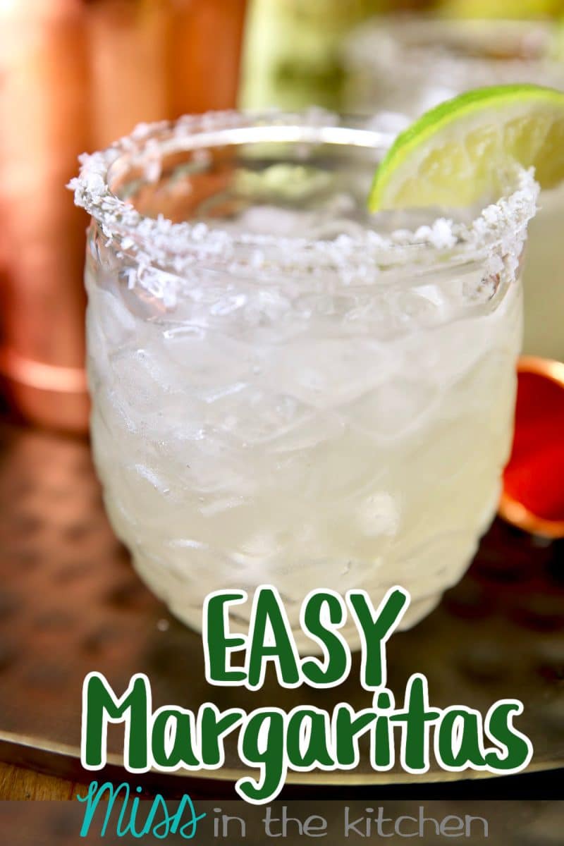 Margarita in a glass with lime slice and salt rim. Text overlay.