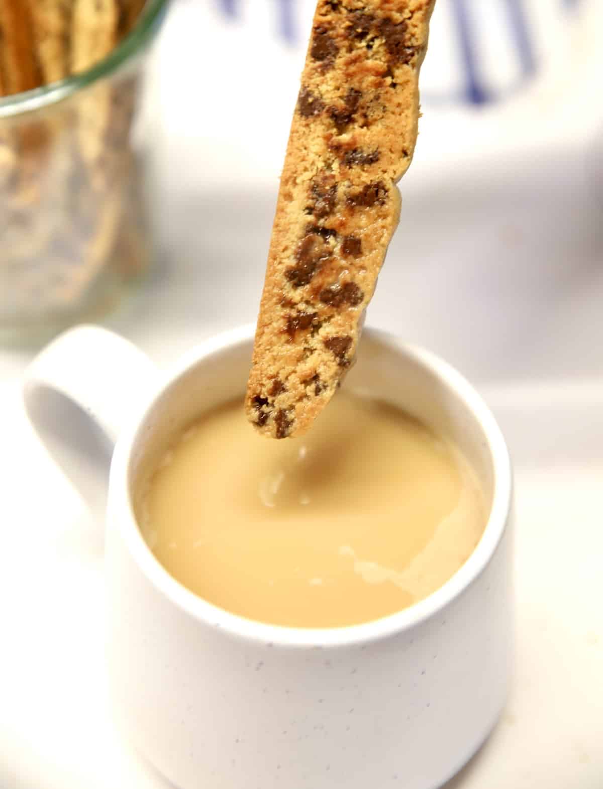 Biscotti dipping into coffee cup.
