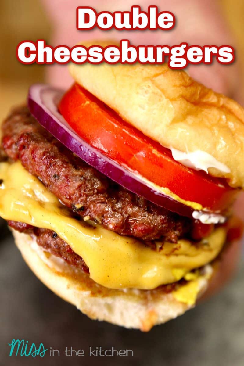 Double cheeseburger in hand, text overlay.
