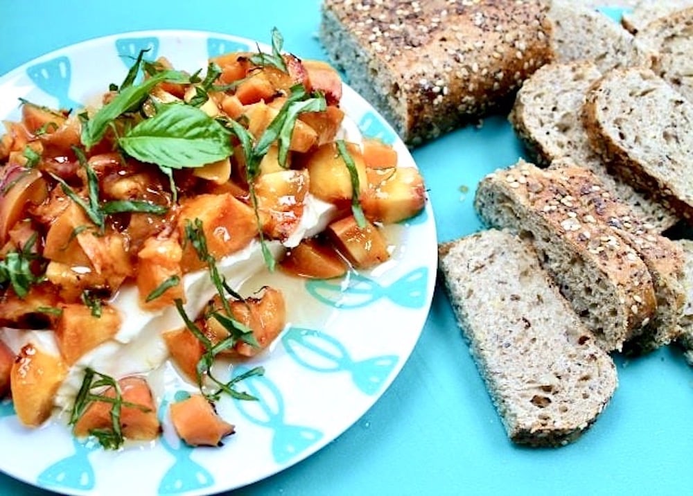 chopped peaches over cream cheese with basil, sliced bread