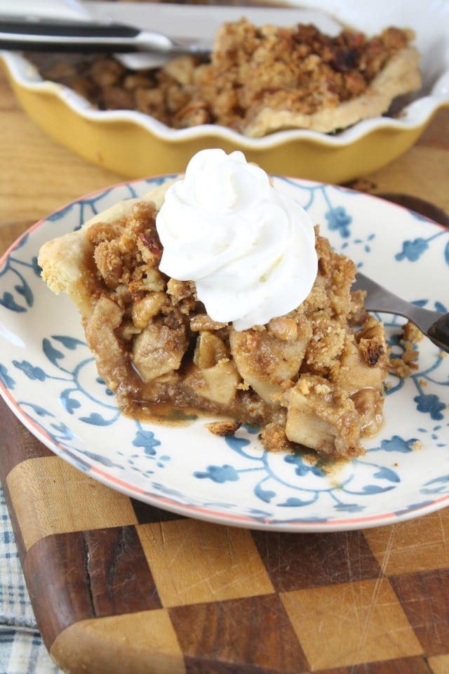 Slice of Apple Crumb Pie with whipped cream
