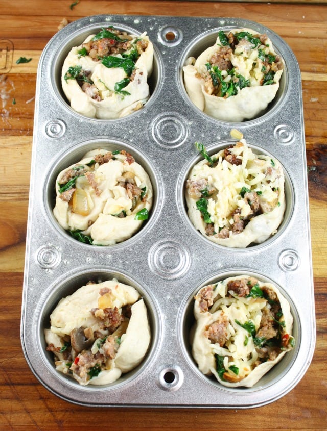 Muffin tin filled with Zesty Sausage and Spinach Ranch Rolls ~ missinthekitchen.com