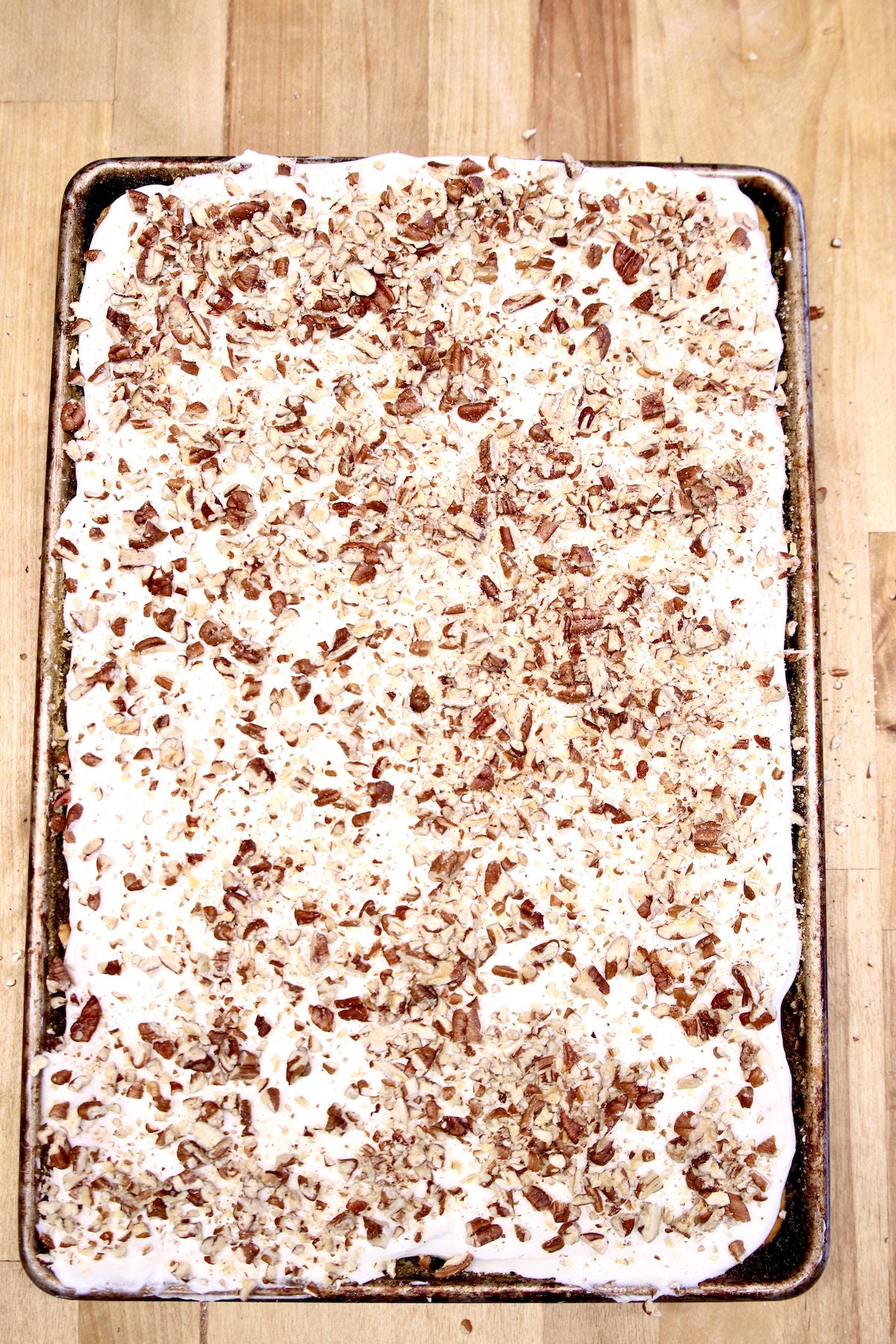 sheet cake with cream cheese icing and pecans
