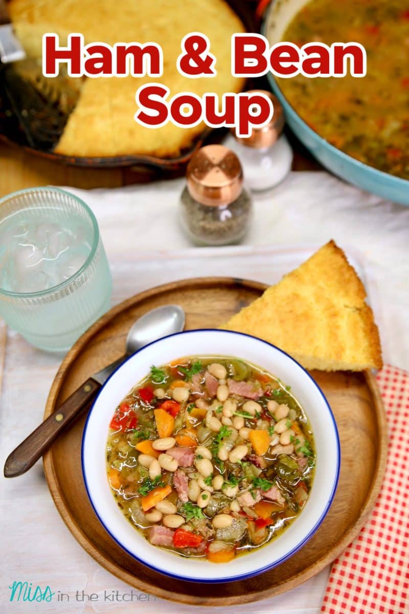 Ham & Bean Soup in a bowl with cornbread on the side. Text overlay.