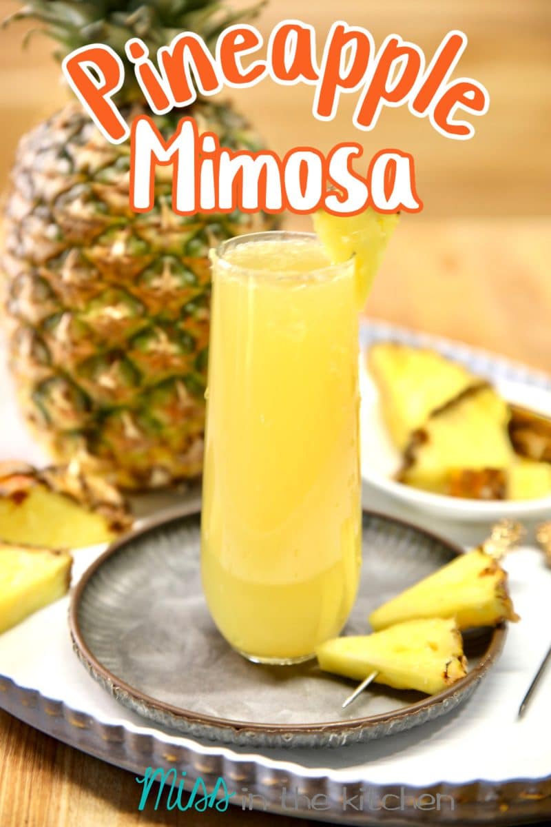 Pineapple Mimosa cocktail with whole pineapple in background. Text overlay.