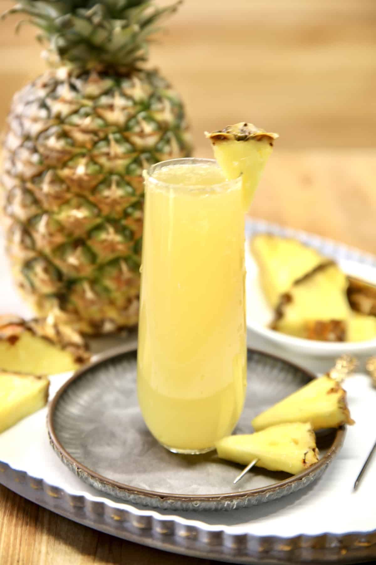 Pineapple mimosa with pineapple garnish.