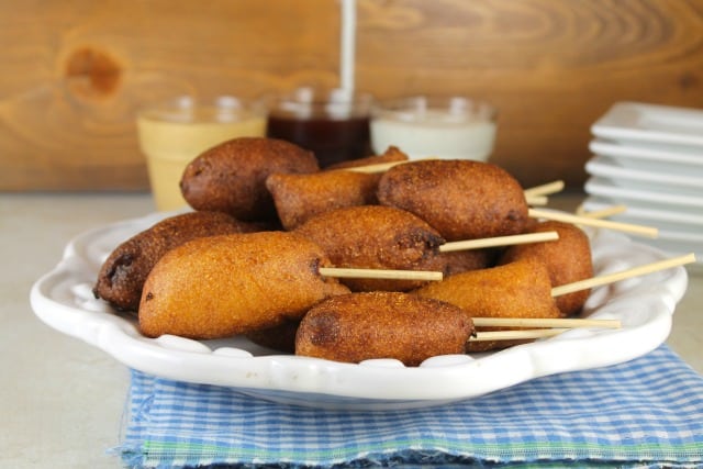 Homemade Mini Corn Dogs are a tasty bite- sized snack for family get togethers and game day parties. A real family favorite! Get the recipe at MissintheKitchen.com